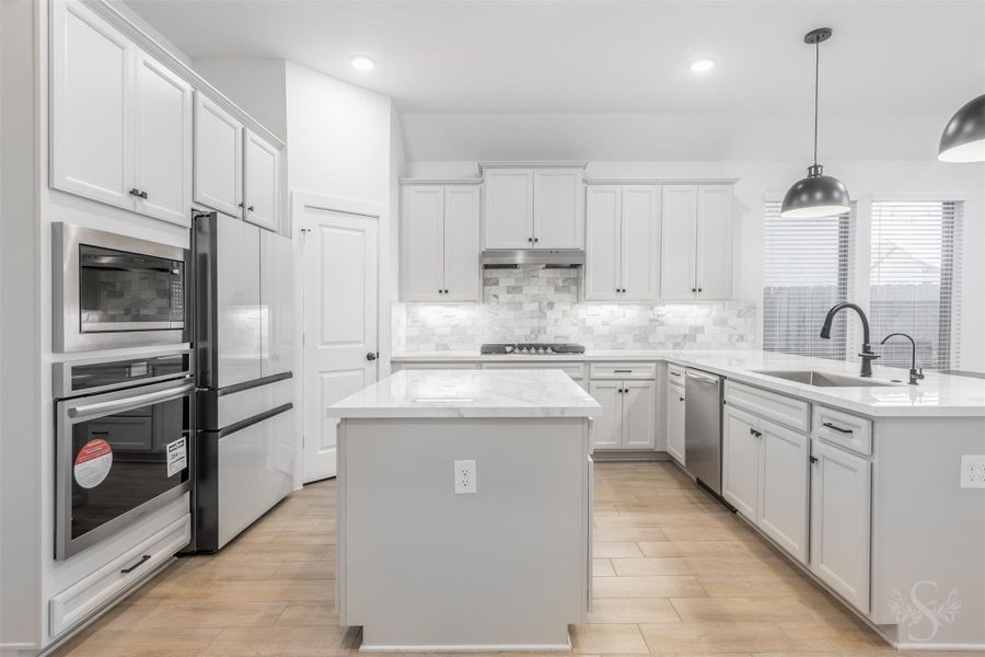 The gourmet kitchen showcases stunning porcelain countertops while offering exceptional durability and modern appeal. Paired with sleek cabinetry, pendant lighting, and a spacious island, this fresh and contemporary design creates a showstopping culinary space perfect for everyday living and entertaining. The gourmet kitchen showcases stunning porcelain countertops while offering exceptional durability and modern appeal. Paired with sleek cabinetry, pendant lighting, and a spacious island, this fresh and contemporary design creates a showstopping culinary space perfect for everyday living and entertaining.