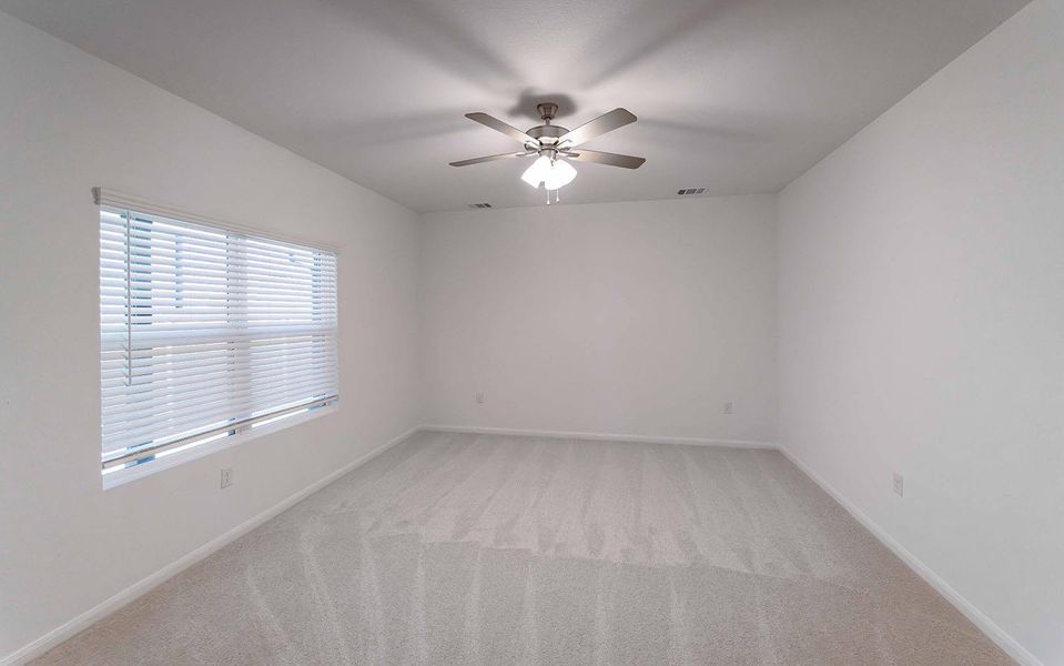 Unfurnished room with light carpet and ceiling fan Unfurnished room with light carpet and ceiling fan
