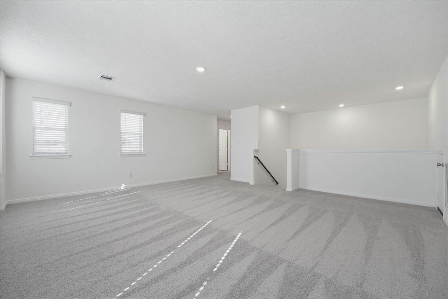 Additional view from the game room looking towards staircase and secondary bedrooms and bathroom to the left.
