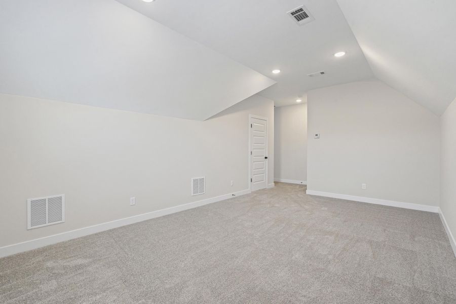 Bonus room with vaulted ceiling, light colored carpet, and recessed lighting Bonus room with vaulted ceiling, light colored carpet, and recessed lighting
