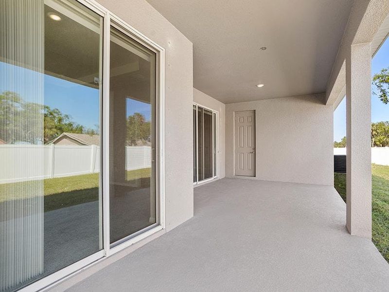 Your interior opens to outdoor living space on your spacious covered lanai - Savannah by Highland Homes