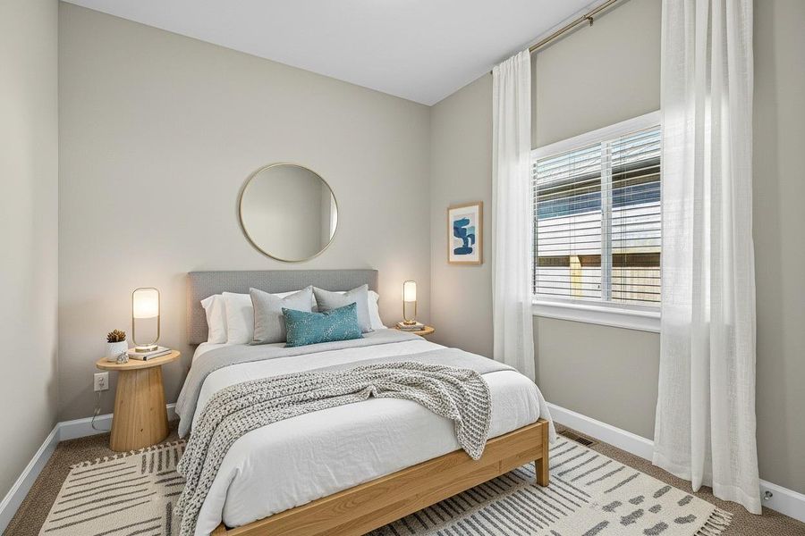 Virtually staged bedroom showcasing a cozy, modern design with neutral tones and ample natural light. Virtually staged bedroom showcasing a cozy, modern design with neutral tones and ample natural light.