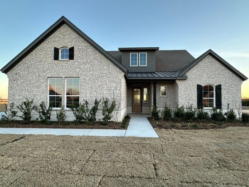 Front exterior of a new home in Fannin Ranch, Leonard, TX, highlighting curb appeal (Image 2). Front exterior of a new home in Fannin Ranch, Leonard, TX, highlighting curb appeal (Image 2).