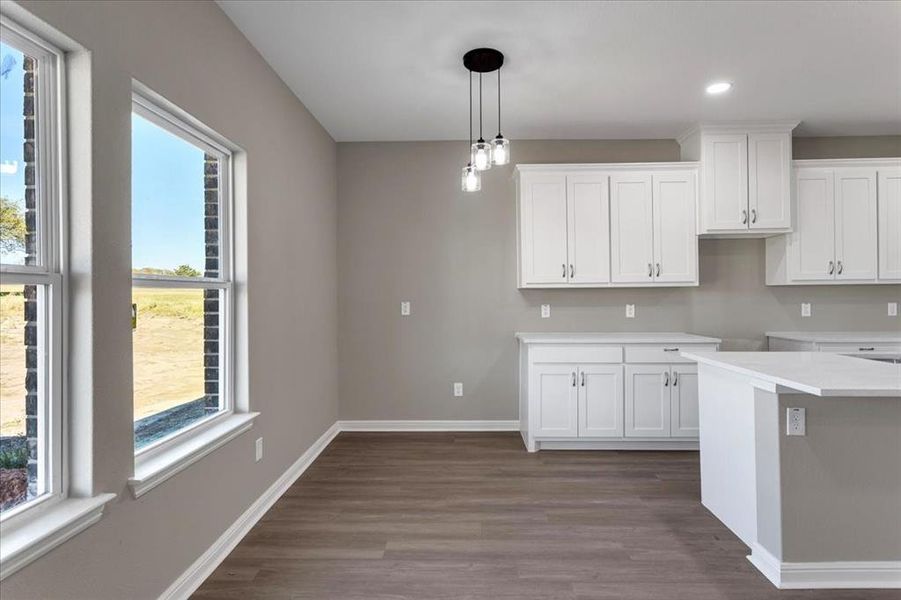 Kitchen with white cabinetry, pendant lighting, dark wood finished floors, and recessed lighting