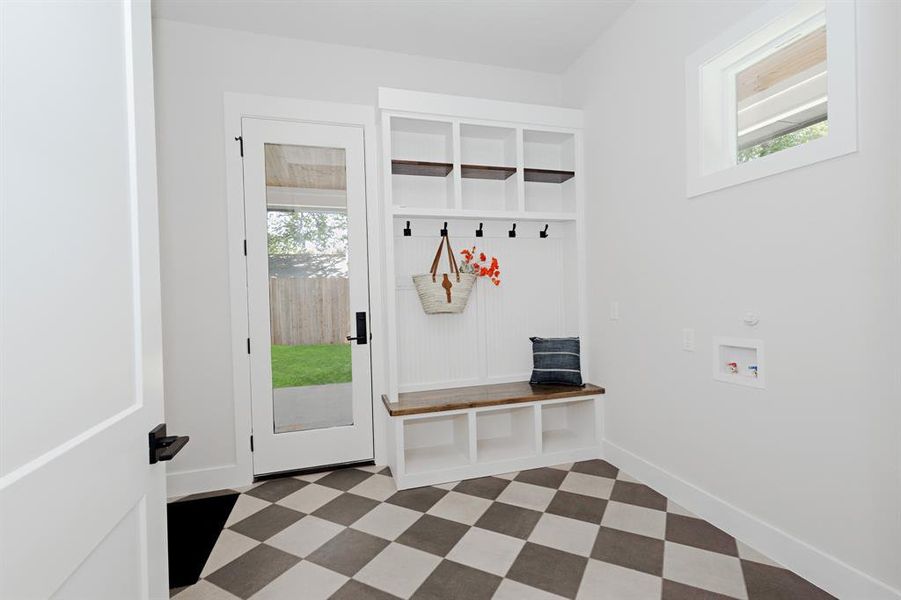 This Laundry Room offers a Built-in Custom Mud Bench with Shelves and Additional Shelving and space to stay organized. This Laundry Room offers a Built-in Custom Mud Bench with Shelves and Additional Shelving and space to stay organized.