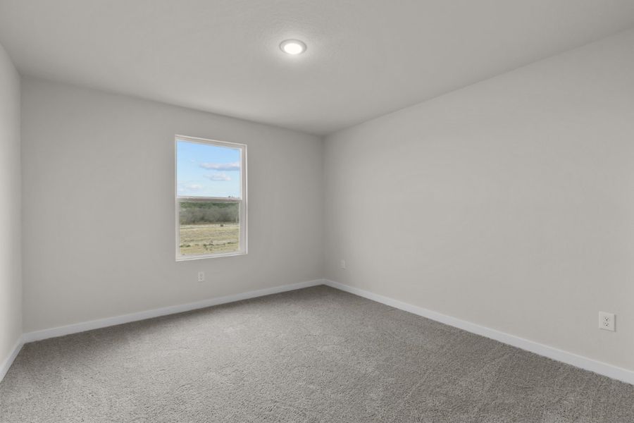 A room with a window and a carpet.