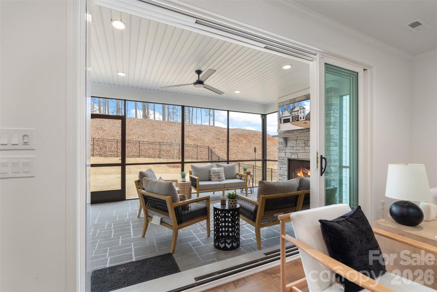 Triple sliding door leading to screened in porch from the livingroom.