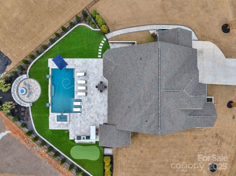 Fabulous outdoor oasis complete with pool, spa, kitchen, firepit & putting green