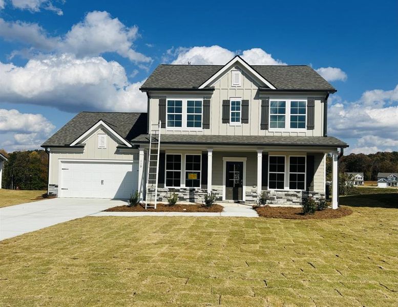 Front exterior of a new home in Sutton's Landing, Statham, GA, highlighting curb appeal (Image 1).
