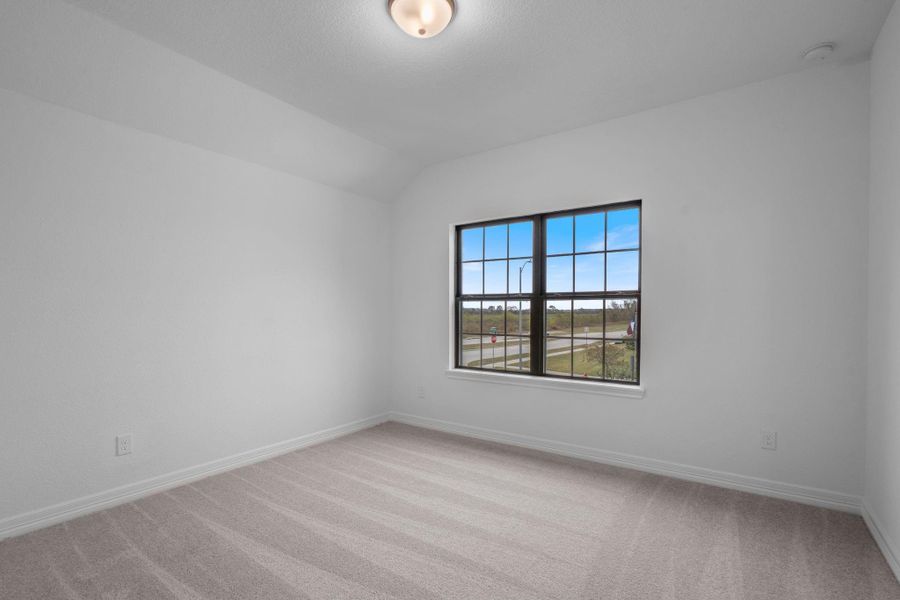 Your secondary bedroom features plush carpet, fresh paint, closet, and a large window that lets in plenty of natural lighting.