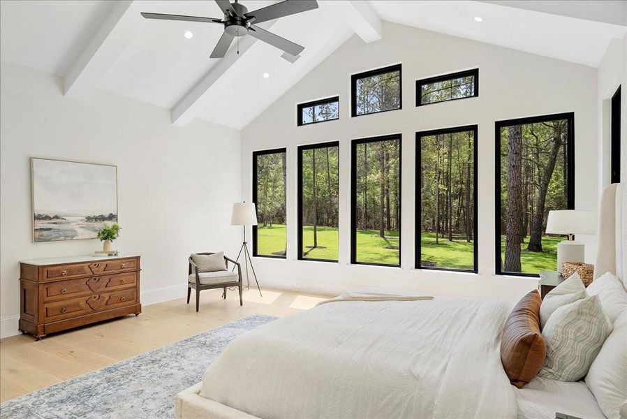 Expansive windows frame the natural beauty of the homesite, filling the primary suite with light while creating a quiet, secluded setting for everyday relaxation.