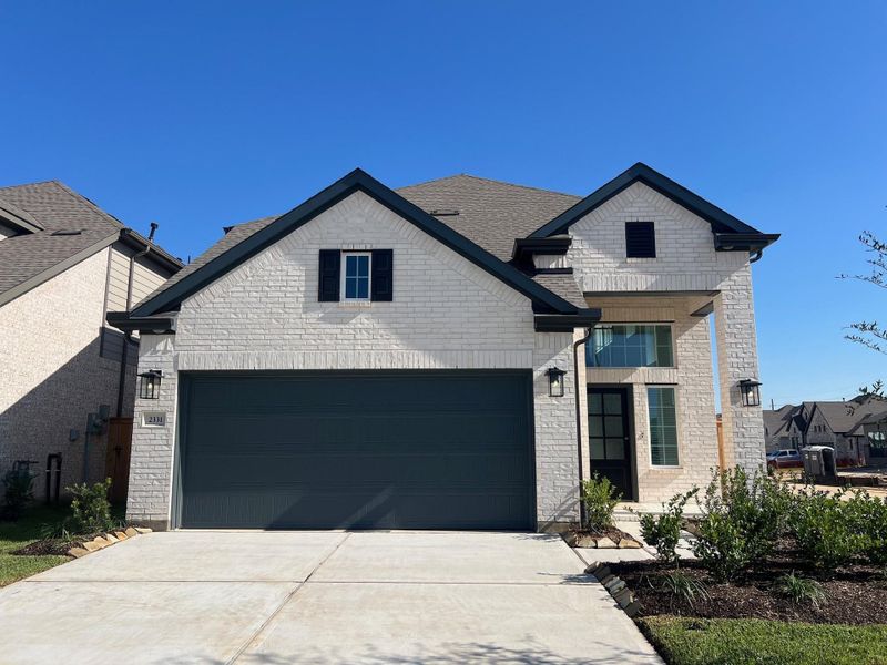 Front exterior of a new home in Wood Leaf Reserve, Tomball, TX, highlighting curb appeal (Image 1). Front exterior of a new home in Wood Leaf Reserve, Tomball, TX, highlighting curb appeal (Image 1).