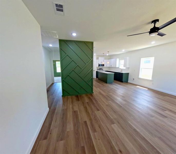 Unfurnished living room with dark wood finished floors, a ceiling fan, and recessed lighting Unfurnished living room with dark wood finished floors, a ceiling fan, and recessed lighting