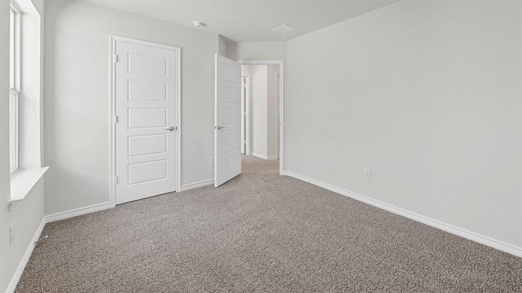 Unfurnished bedroom featuring carpet flooring and baseboards