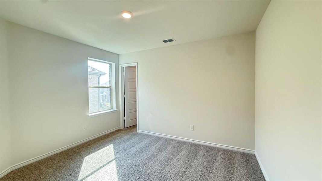 Empty room featuring carpet and baseboards