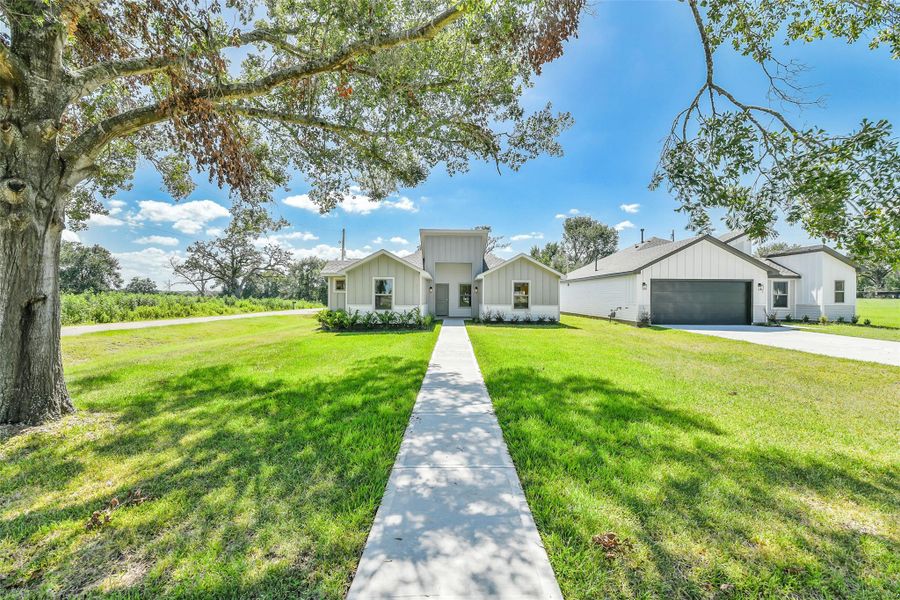 Modern farmhouse situated on an expansive corner lot with sweeping front yard views and added space for outdoor enjoyment.