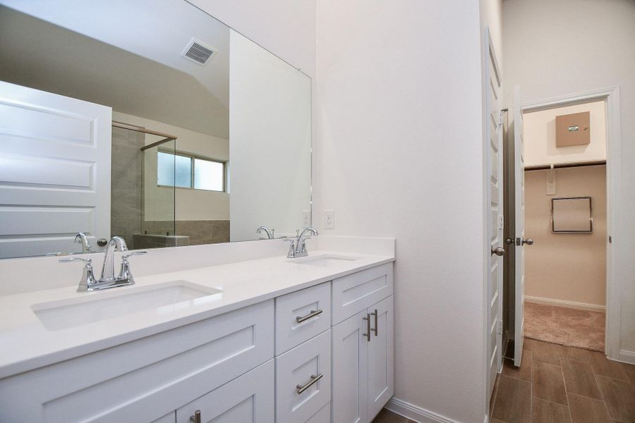 Step into the gorgeous bathroom, equipped with quartz countertops and double sinks!
