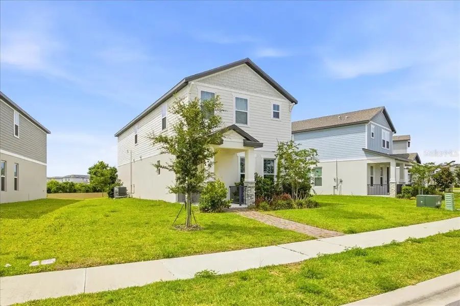 Front exterior of a new home in Highland Ridge, Winter Garden, FL, highlighting curb appeal (Image 23).