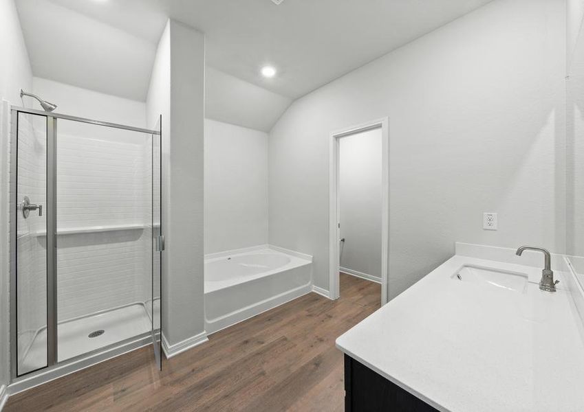 The master bathroom of the Juniper plan has a large, walk-in shower and garden tub.