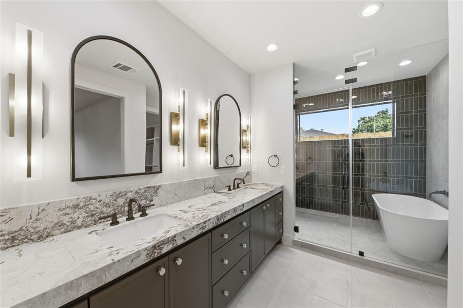 The sophisticated primary bathroom offers a relaxing retreat with a spacious layout, premium fixtures, and timeless style.