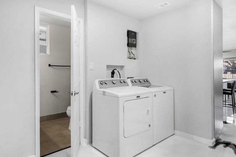 Laundry area featuring baseboards and independent washer and dryer