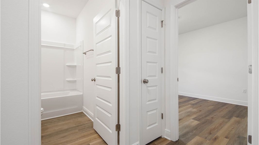 Representative unfurnished interior of a home built from the Delray by D.R. Horton in Caballeros Estates At Hombre, Panama City Beach (Image 16).