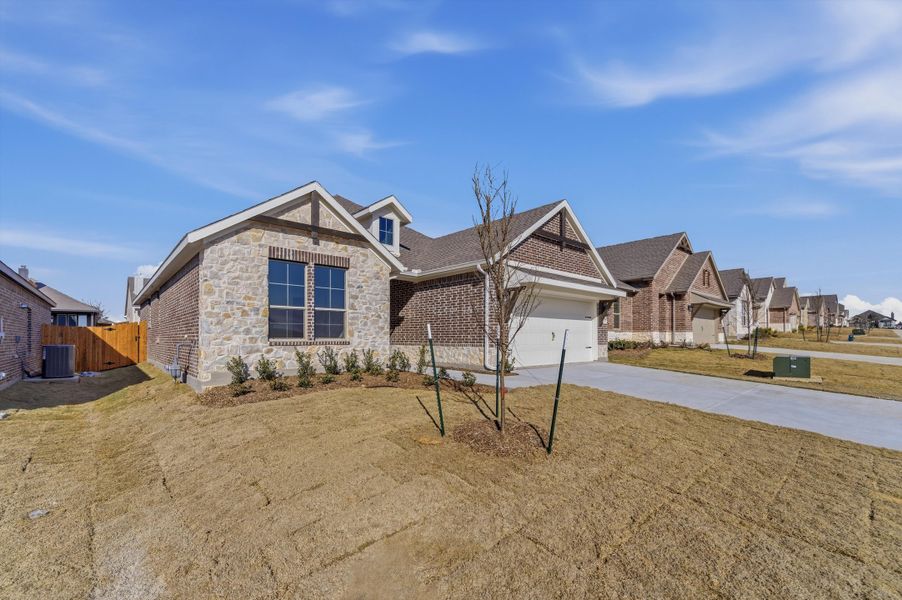 Front exterior of a new home in Liberty Pointe, Gainesville, TX, highlighting curb appeal (Image 15).
