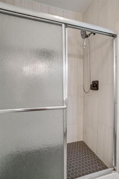 Bathroom featuring a shower with door