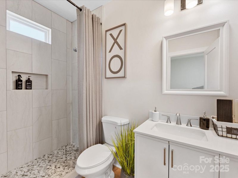 Walk in shower with floor to ceiling tile, niche for beauty items and plenty cabinet space. Walk in shower with floor to ceiling tile, niche for beauty items and plenty cabinet space.