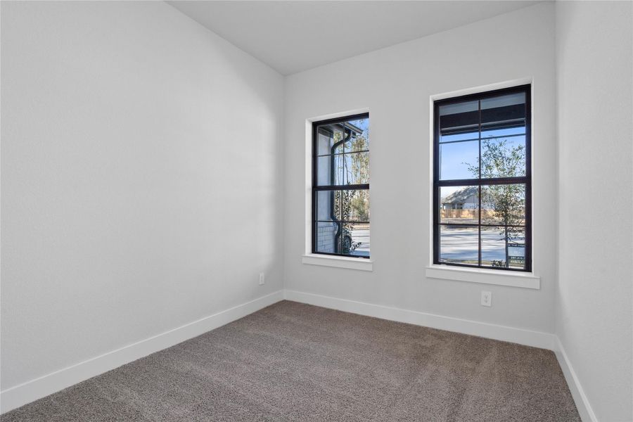 Tucked peacefully in the front of the home is this secondary bedroom. It features plush carpet flooring, neutral toned walls, and large windows. Tucked peacefully in the front of the home is this secondary bedroom. It features plush carpet flooring, neutral toned walls, and large windows.