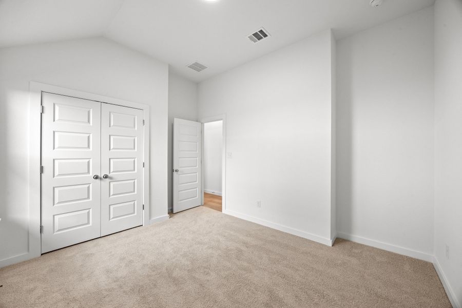 Bedroom in the Turquoise home plan by Trophy Signature Homes – REPRESENTATIVE PHOTO