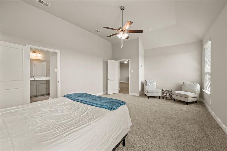 Alternate view of the primary suite showing room for a seating area and easy access to the primary bath.