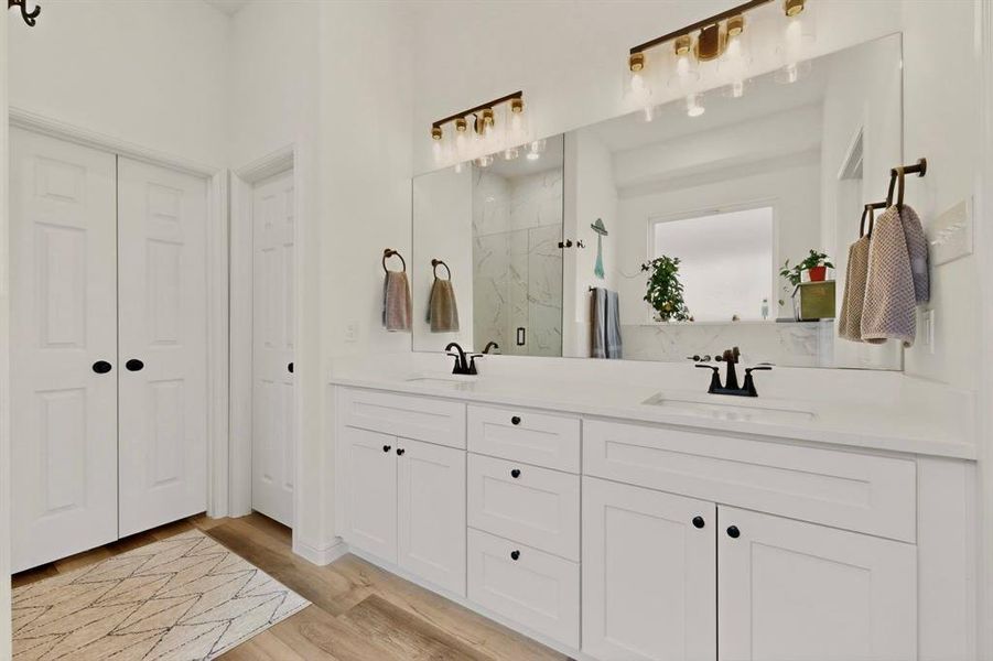 Dual vanity with white cabinetry and quartz countertops