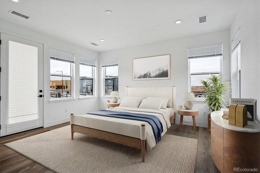 Virtually staged primary bedroom w/walk-out access to the balcony Virtually staged primary bedroom w/walk-out access to the balcony