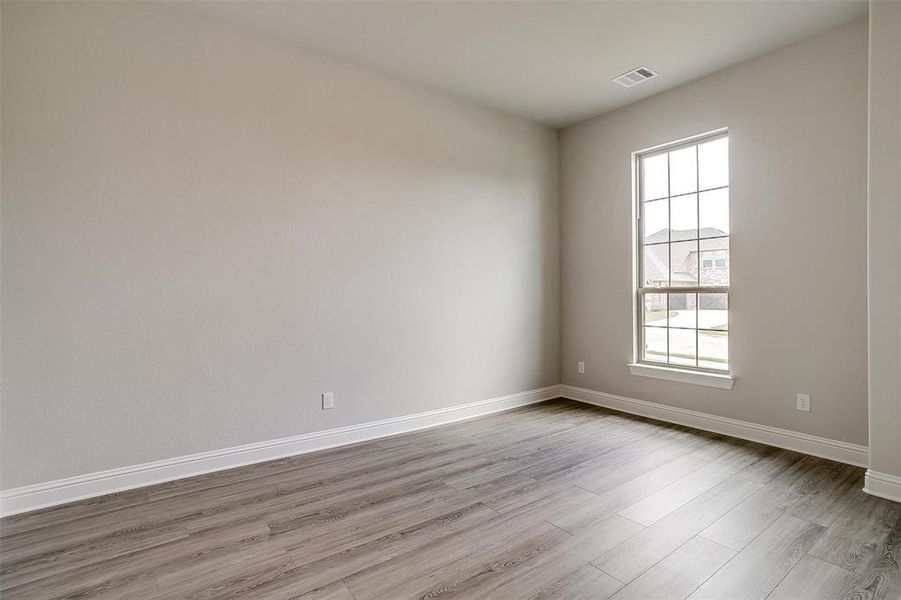 Spare room with hardwood / wood-style floors