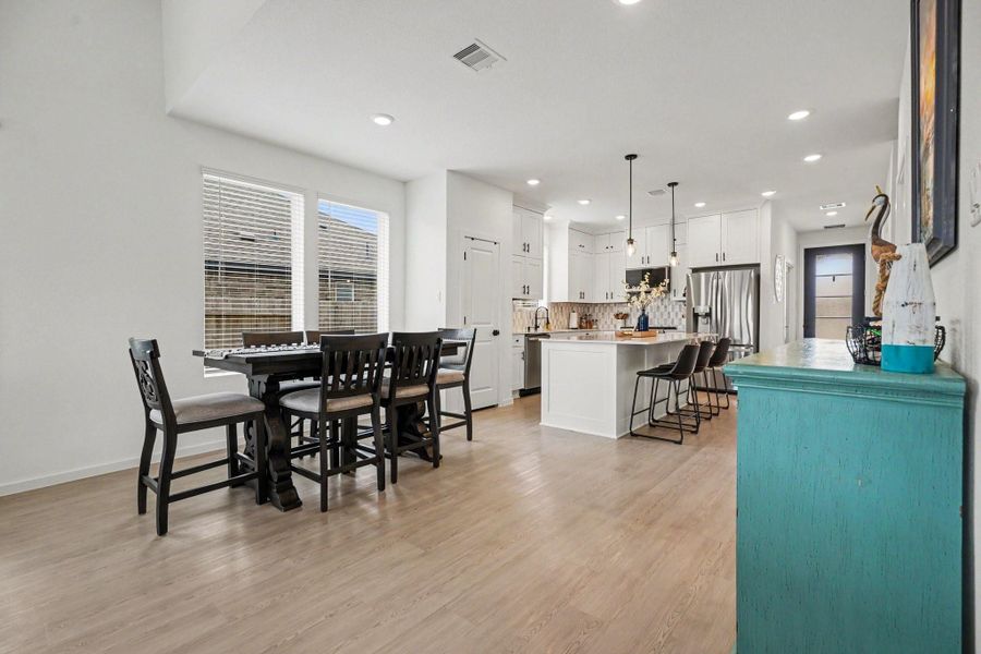 Open-concept dining area with abundant natural light and a seamless connection to the kitchen, creating an inviting and functional layout. Open-concept dining area with abundant natural light and a seamless connection to the kitchen, creating an inviting and functional layout.