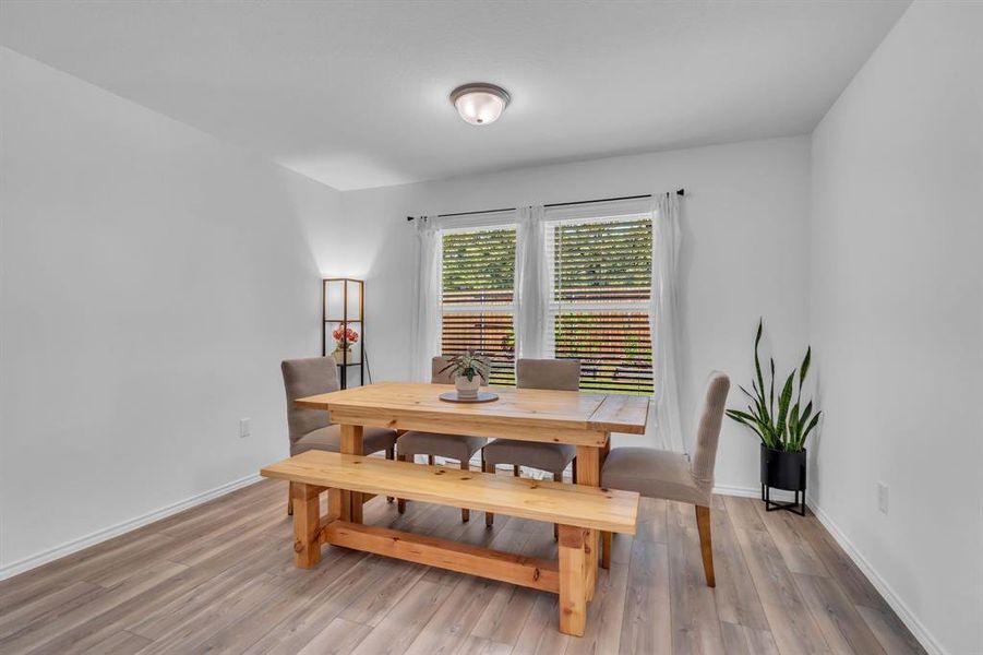 Dining area with light wood-style floors