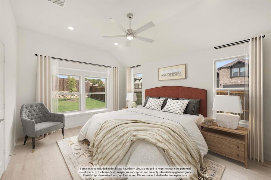 Bedroom with vaulted ceiling, ceiling fan, hardwood floors, and large windows with backyard view