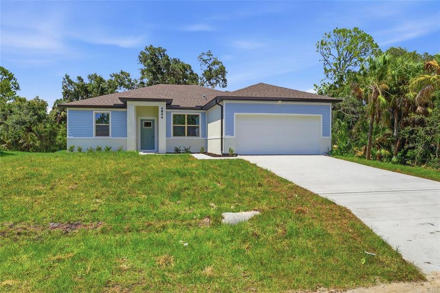 Front exterior of a new home in , North Port, FL, highlighting curb appeal (Image 2). Front exterior of a new home in , North Port, FL, highlighting curb appeal (Image 2).