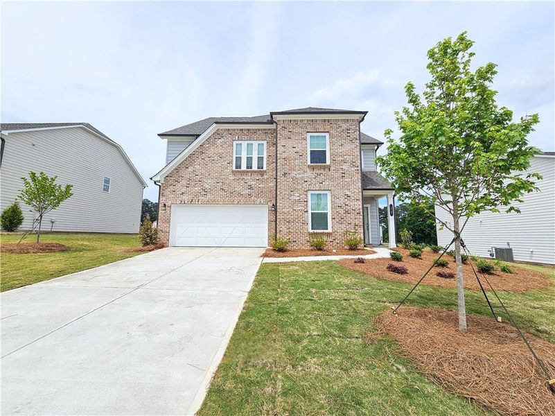 Front exterior of a new home in The Estates at Casteel, Bethlehem, GA, highlighting curb appeal (Image 1). Front exterior of a new home in The Estates at Casteel, Bethlehem, GA, highlighting curb appeal (Image 1).