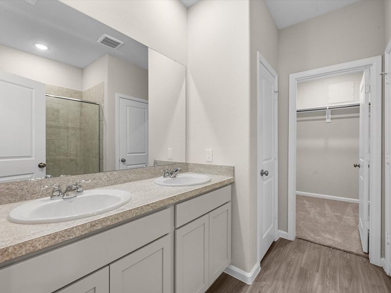 A bathroom with a large mirror.