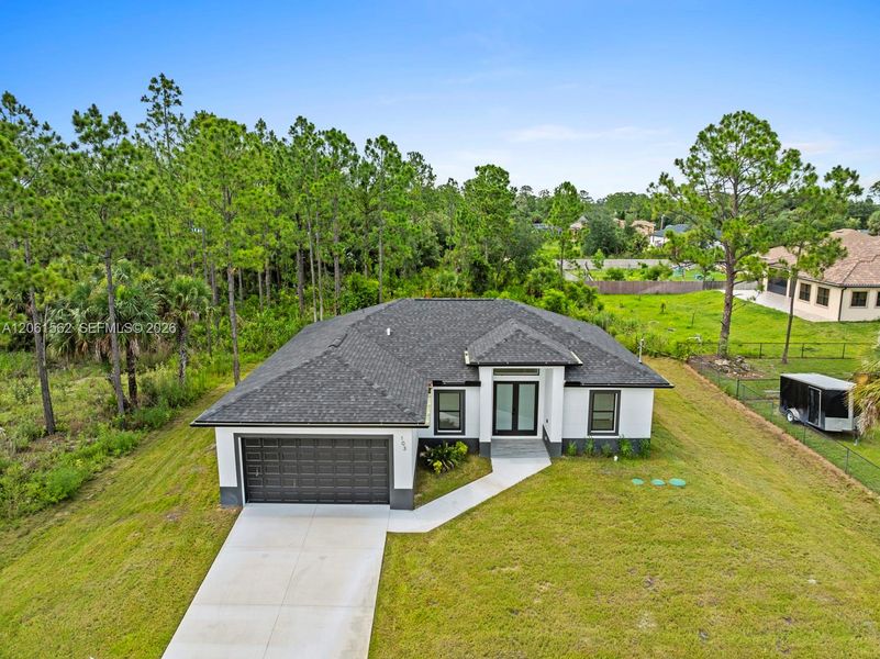 Front exterior of a new home in , Lehigh Acres, FL, highlighting curb appeal (Image 2). Front exterior of a new home in , Lehigh Acres, FL, highlighting curb appeal (Image 2).