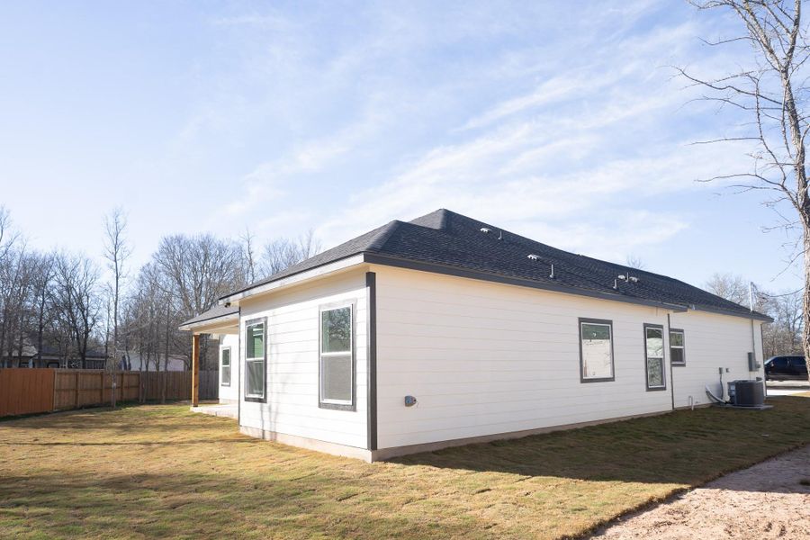 View of side of property featuring a cooling unit