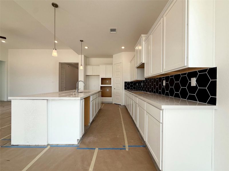 The kitchen is the heart of the home, featuring modern appliances, ample cabinetry, and an oversized island that’s perfect for meal prep, casual dining, and family gatherings.