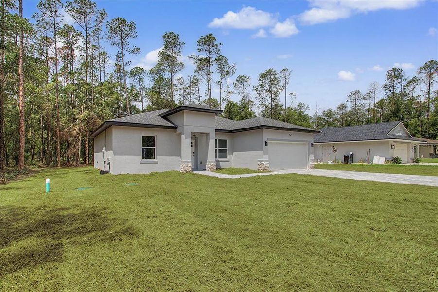 Front exterior of a new home in , Citrus Springs, FL, highlighting curb appeal (Image 21). Front exterior of a new home in , Citrus Springs, FL, highlighting curb appeal (Image 21).