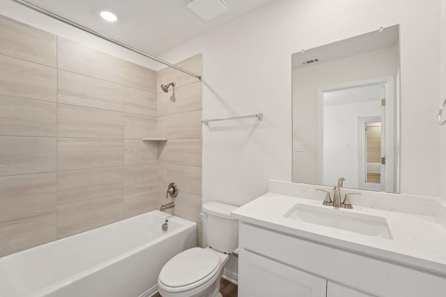 Bathroom featuring shower / washtub combination, vanity, and recessed lighting