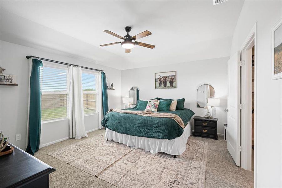 Bedroom featuring light colored carpet and a ceiling fan