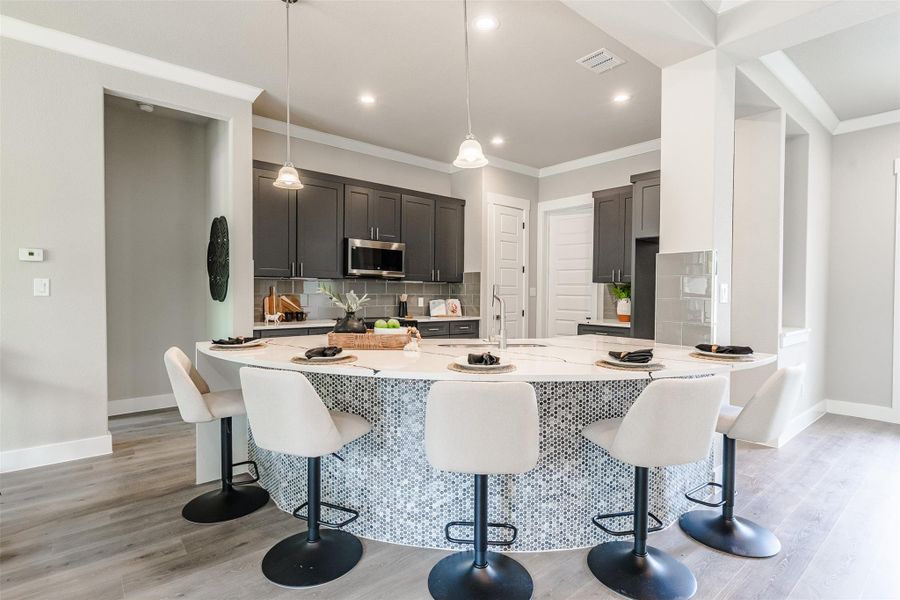 An inviting kitchen island provides ample counter space and casual seating for entertaining guests. An inviting kitchen island provides ample counter space and casual seating for entertaining guests.