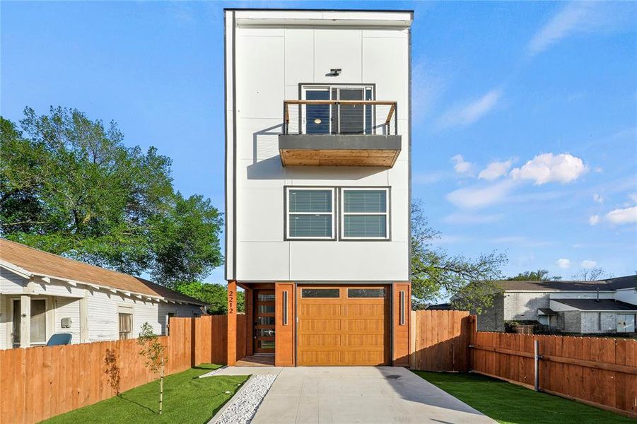 Contemporary home featuring a garage and driveway Contemporary home featuring a garage and driveway