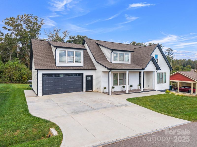 Front exterior of a new home in , Candler, NC, highlighting curb appeal (Image 26).